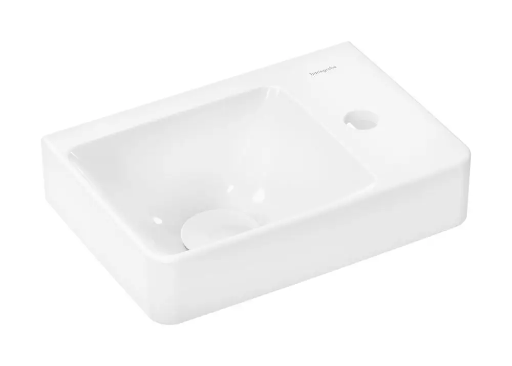 Weißes Handwaschbecken mit rechteckiger Form und integrierter Ablage, ausgestattet mit einem Hahnloch, ohne Überlauf. Marke: Hansgrohe.